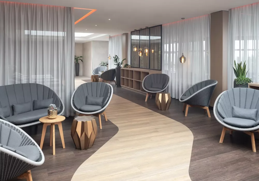 Exclusive lounge area featuring modern designer armchairs, stylish side tables, and ambient lighting