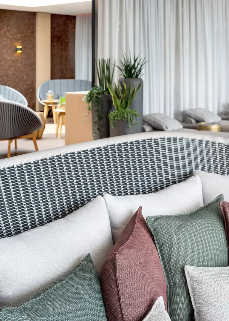 Stylish lounge area at Ostsee Therme Scharbeutz featuring high-quality upholstered furniture, decorative cushions, and modern design elements
