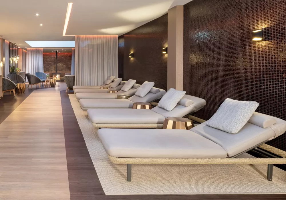 Exclusive relaxation room at Ostsee Therme Scharbeutz featuring premium loungers, stylish design elements, and ambient lighting