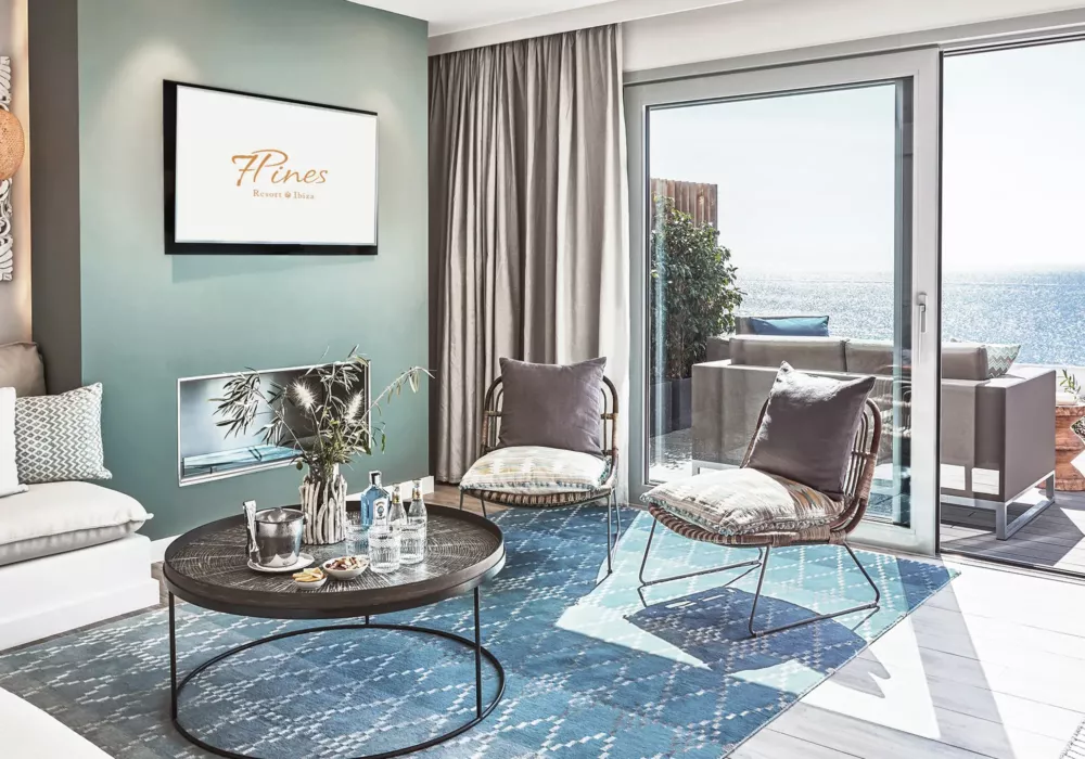 Elegant living room at 7Pines Resort Ibiza featuring modern design, stylish furniture, and a sea view from the terrace