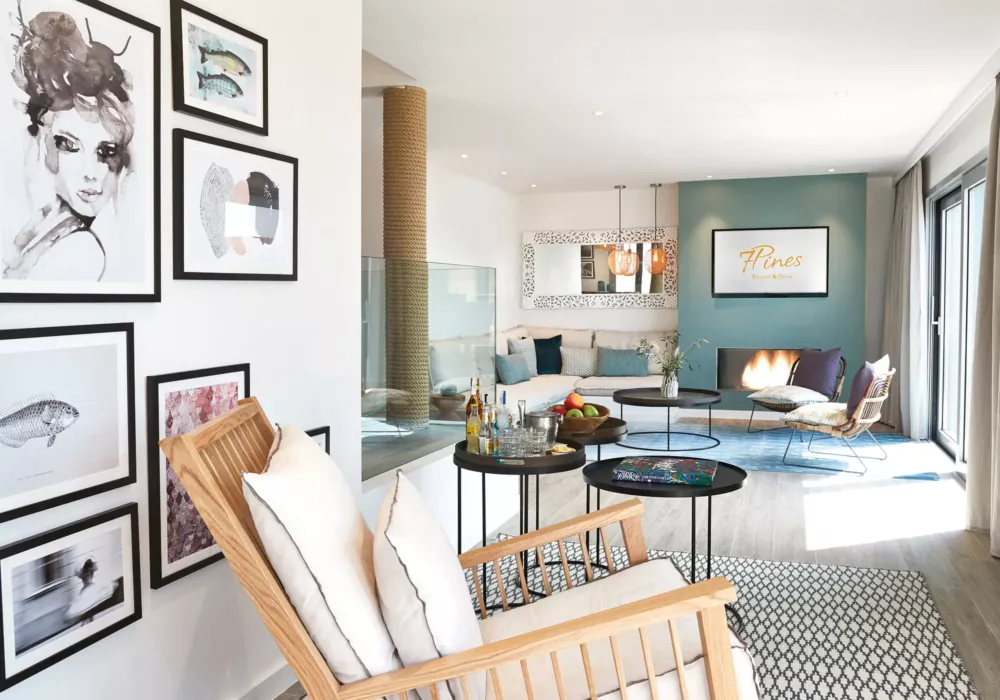 Modern and stylish living room at 7Pines Resort Ibiza featuring a cozy seating area, wall art gallery, and elegant decor