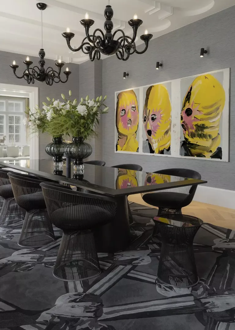 Elegant dining room with a black glass table, modern wire chairs, artistic design rug, and striking wall art.